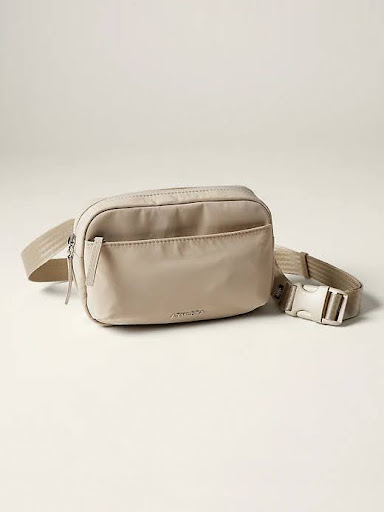 A beige polyester crossbody belt bag with adjustable and detachable straps