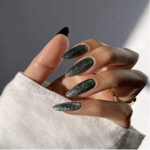 Woman's hand with black nail polish and sparkle design
