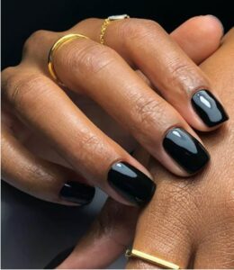 Woman's hand with black glossy nails