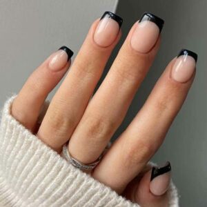 Woman's hand with black french tip nails
