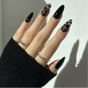 Woman's hand with black heart nail design